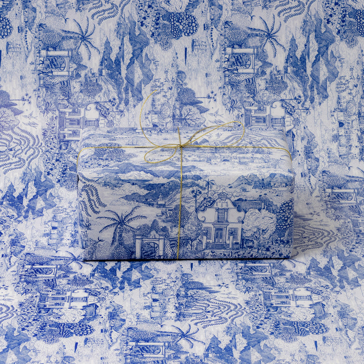 Gift box wrapped in blue and white patterned paper on a matching background