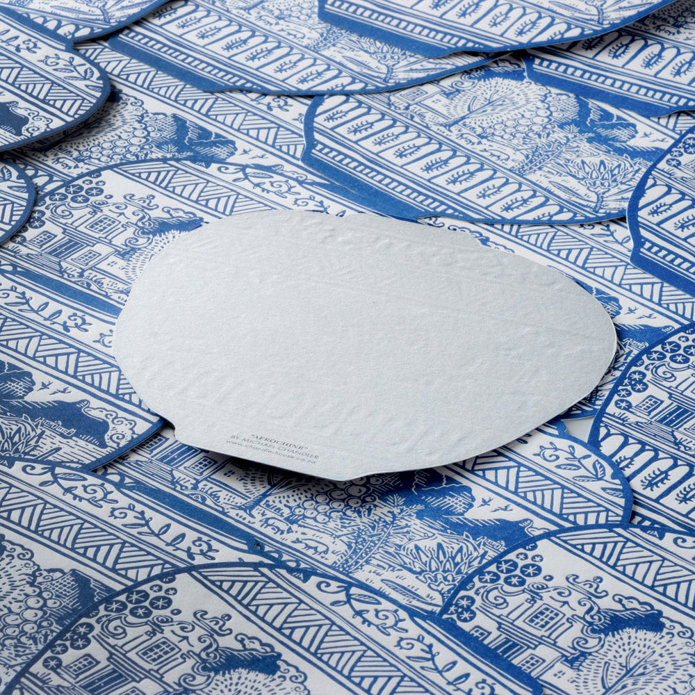 Plain white back side of Postcard on a blue and white patterned surface