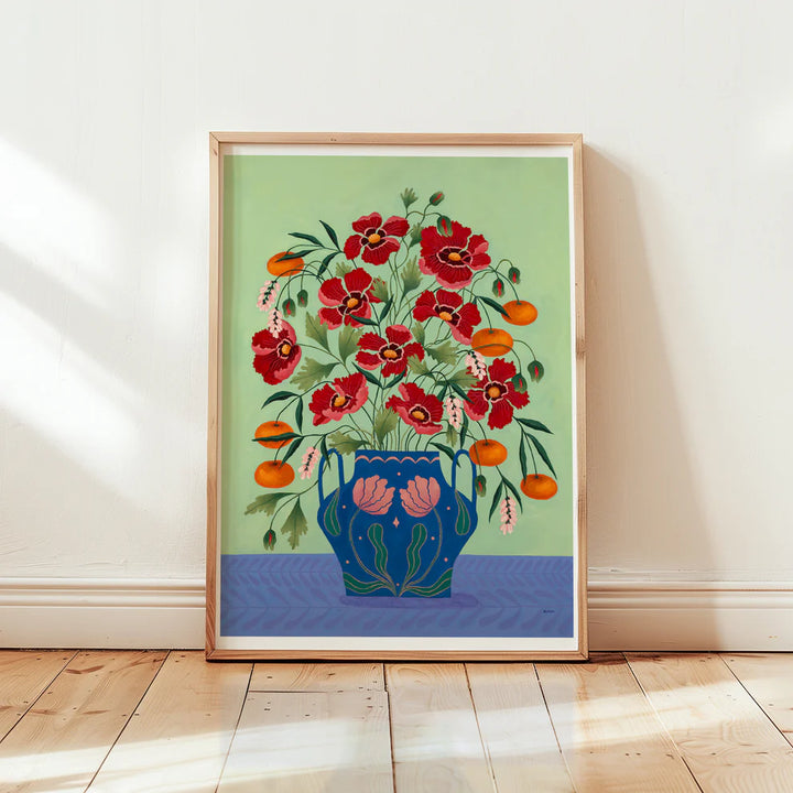 Framed Fine art print of a bright burgundy floral display in a blue vase with light pink floral motif.