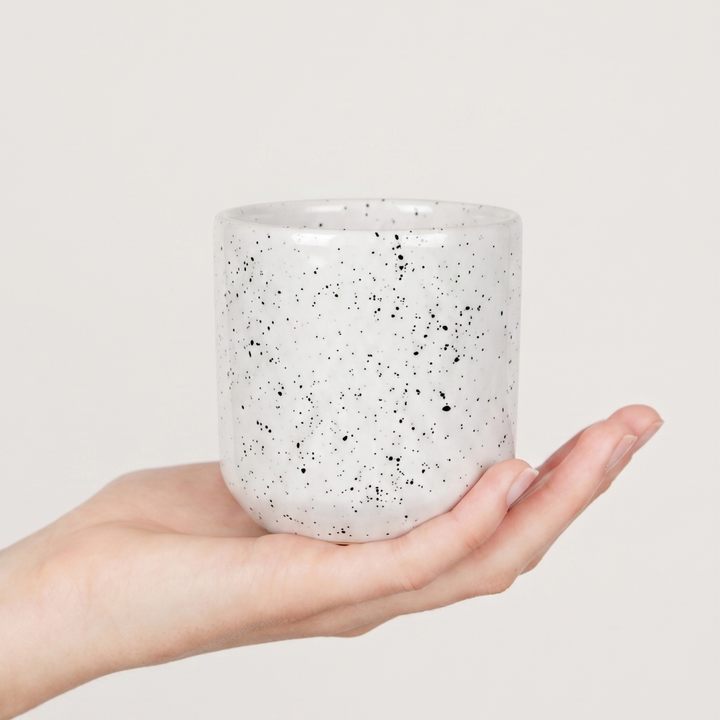 someone holding ceramic cup 