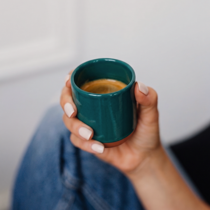 Person holding a ceramic cup