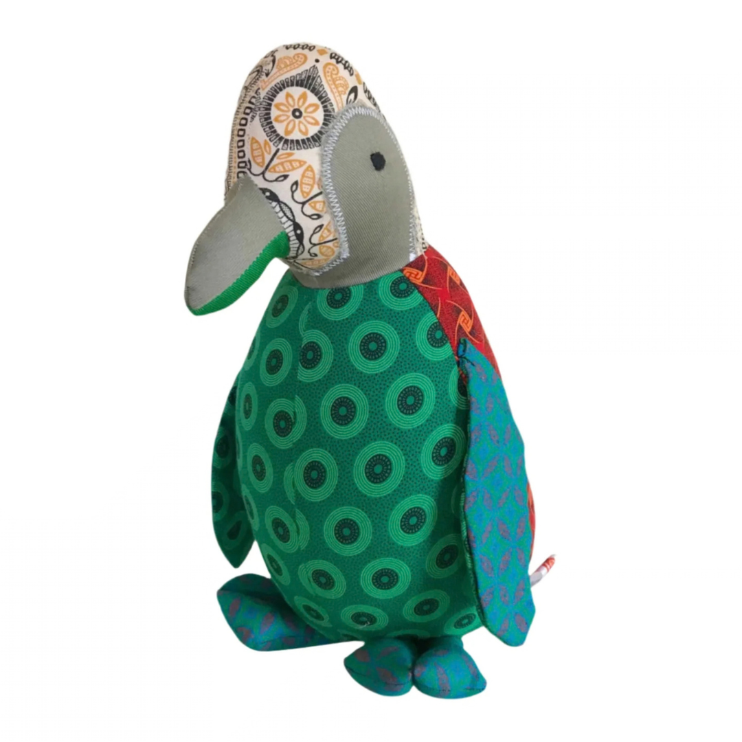 front of Penguine Shweshwe Stuffed Toy, with colourful fabric on white background