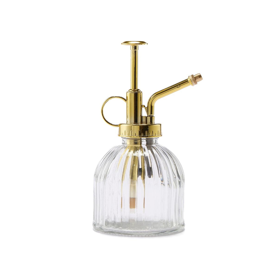Clear glass bottle with gold metal nozzle on a white background