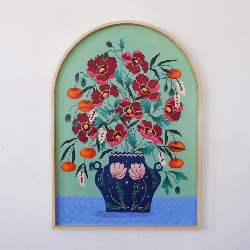Arch Framed Fine art print of a bright red floral display in a deep blue vase with light pink floral motif.