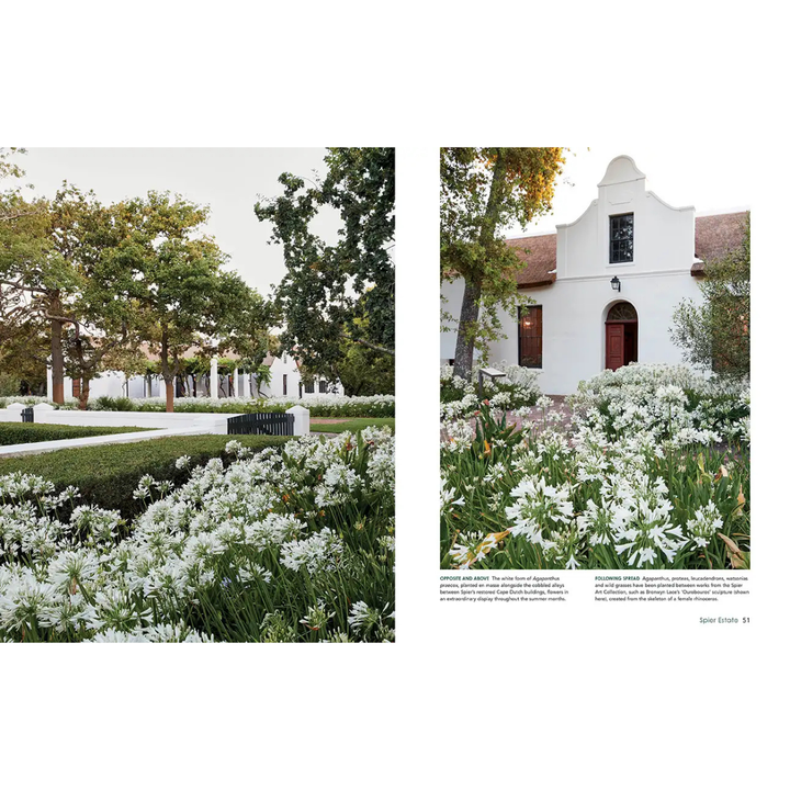 White building with a garden and trees in the foreground south african indigenous