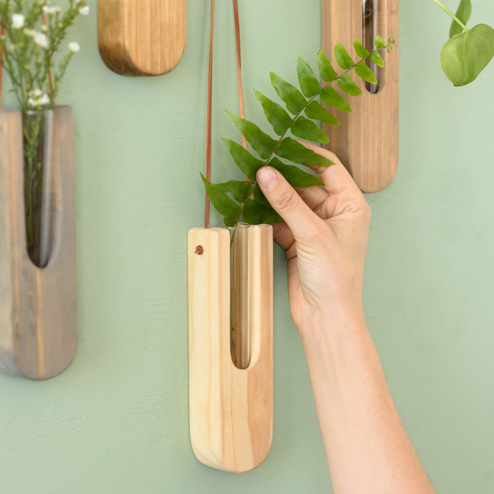 Decorative Wall Propagation Vase close up show show colour with someone adding a leaf